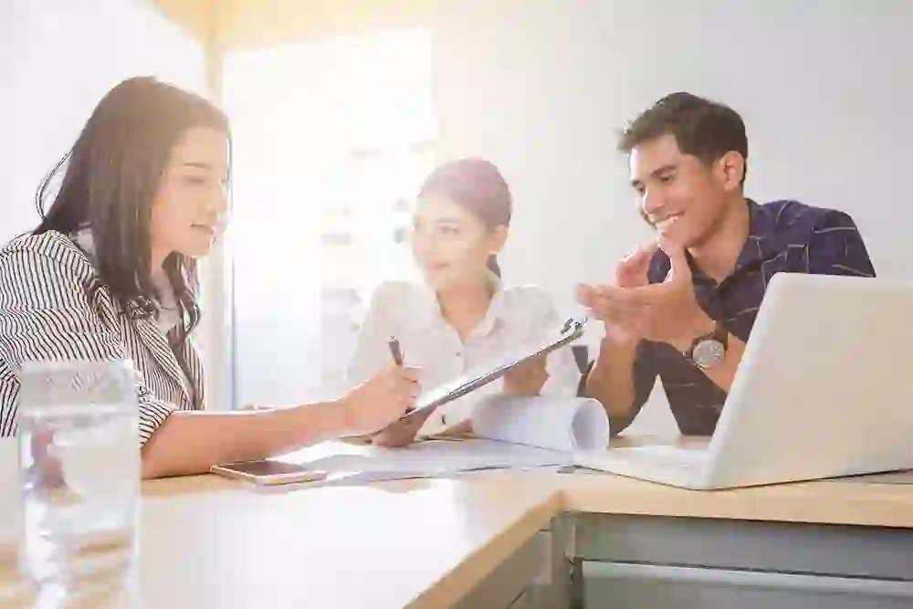 figure-6-small Office manager explaining to 2 patients